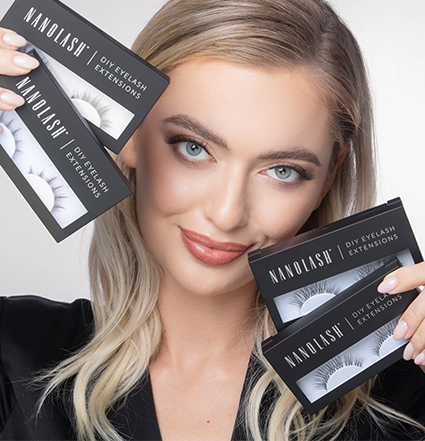 Blonde woman holding eyelash extension kits